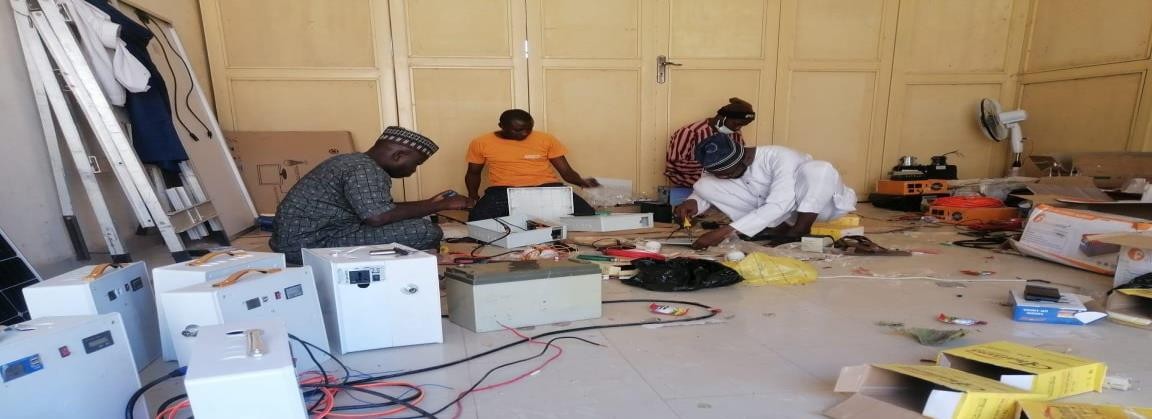 Trainees assembling solar compact generators
